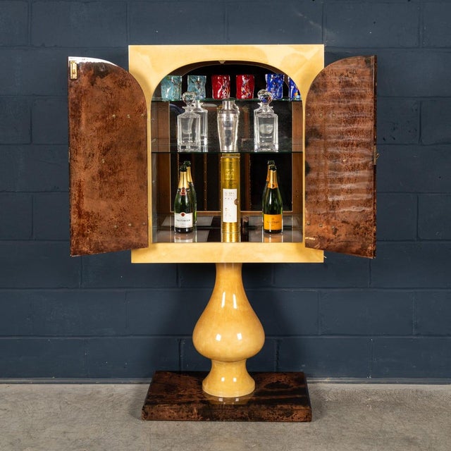A distinctive and highly collectible bar cabinet by aldo tura, dating to the 1960s, exemplifying the designer’s signature...