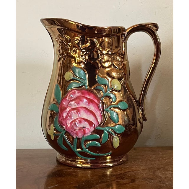 Antique 19th century English Regency Staffordshire copper luster pitcher. Decorated with relief molded pink roses. Useful...