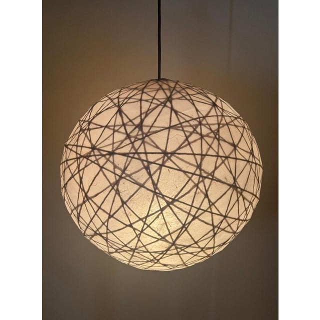 A truly exceptional and rare mid-century modern cocoon pendant lamp from the 1970s, most likely manufactured in germany....