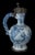 The blue and white wine jug has a round body standing on a wide, spreading foot, and a slightly conical neck with pouring...