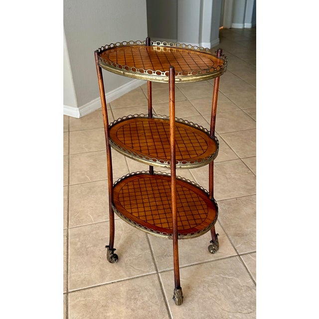 19th century French kingwood and parquetty inlaid three tier etagere. Beautiful mahogany wood frame with ormolu scrolling...