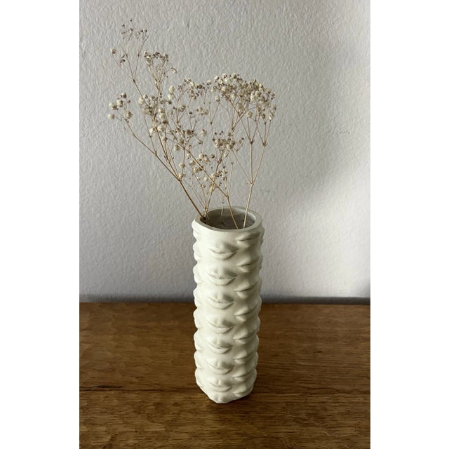 Resembling the works of Richard Etts, and Italian artist Pietro Fornasetti, many Lips surround this vase. On the bottom of...