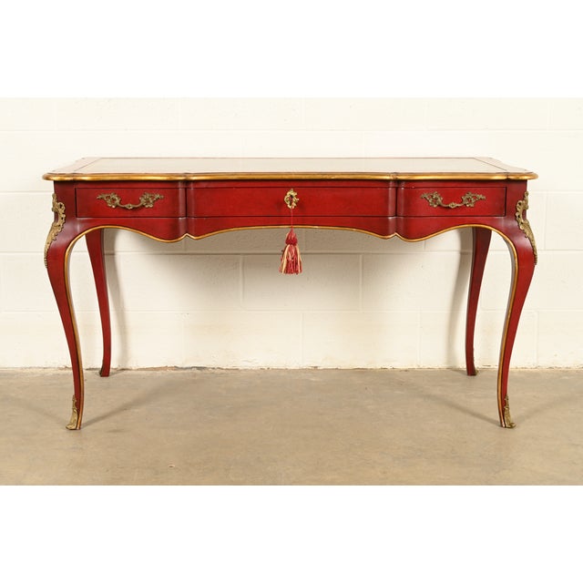 A gorgeous French Louis XV style writing desk or bureau plat desk By John Widdicomb USA, 1981 Carved red lacquered and...