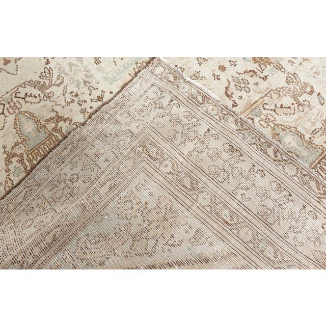 A hand-knotted wool antique Persian Malayer rug dating back to 1920. The main field displays a pattern referring to the...