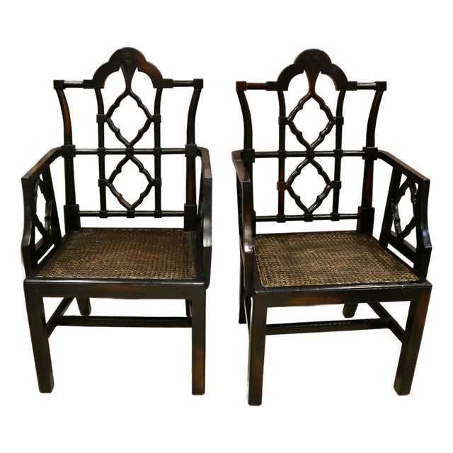 Vintage Chinoiserie Black Carved Wood Arm Chairs With Caned Seat - A Pair For Sale