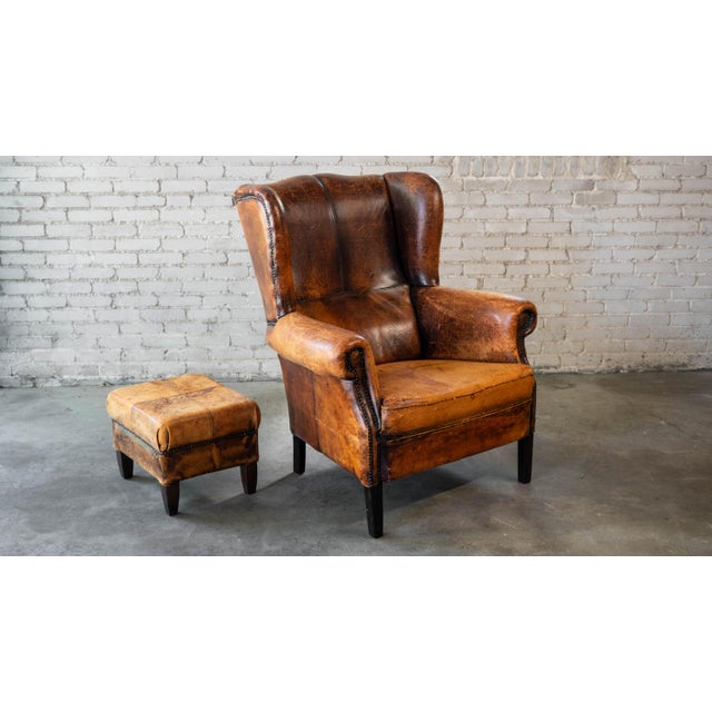 Animal Skin 1970s Vintage Art Deco Distressed Cognac Leather Wingback Chair & Ottoman For Sale - Image 7 of 16