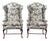 A pair of George III style wingback armchairs, Early 20th century. Each with glazed chintz toile upholstery, raised on...