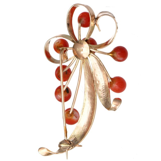 Red coral droplets that look like red berries shine on this exquisite swirl pin. Yellow gold engravings create the...