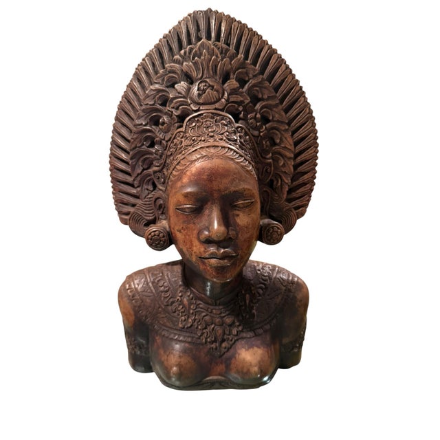 A pair of busts depicting women from Bali with traditional, elaborate headpieces and jewelry. Handmade and painted.