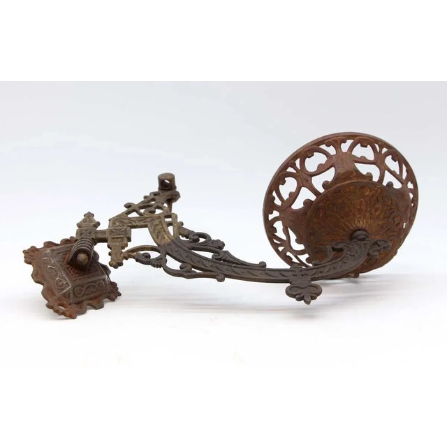 Black cast iron antique oil lamp holder with decorative Victorian details. There is some rust from age and use. The...