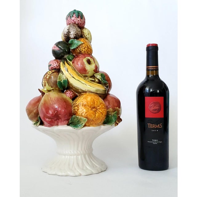 Offering a LARGE 1960s Italian porcelain hand painted topiary depicting a white basket filled with an array of fruits...