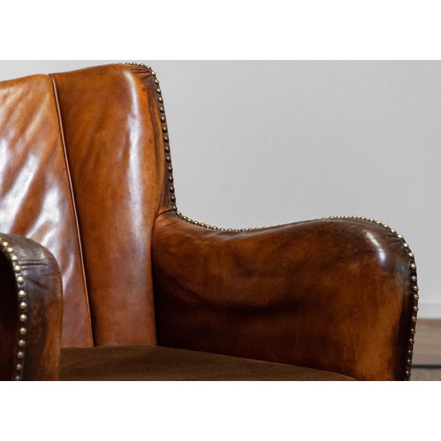 Club Chair in Tan Brown Patinated Leather in the style of Fritz Hansen, 1930s, in Good conditions. Designed 1920 to 1949...