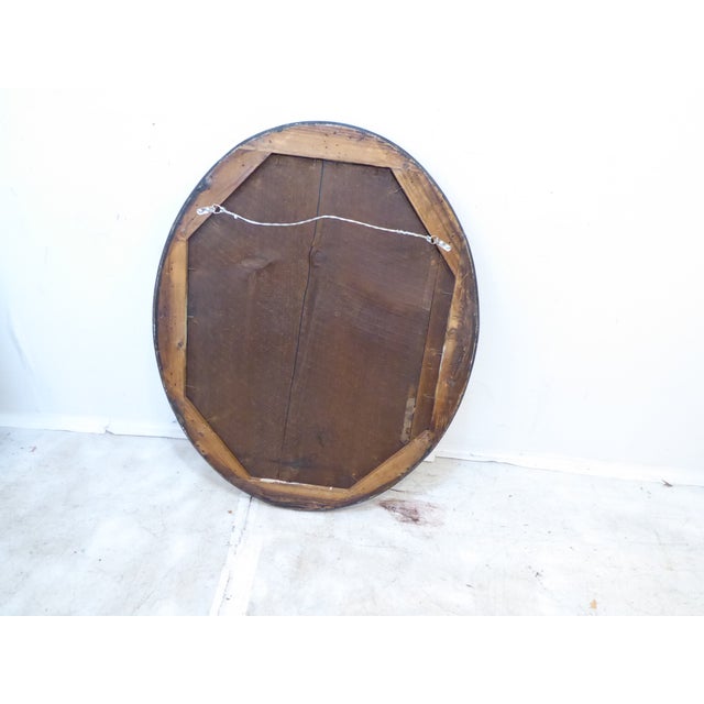 This early 19th century English Regency mirror with silver-gold cove, measures 29"H x 23.25"W.
