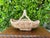 Beautiful handcrafted Italian ceramic basket featuring a woven body, braided rim, and sculptural twisted handle. Finished...
