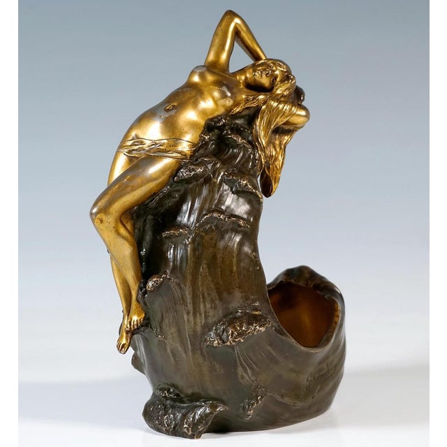 Serpentine crocodile with head raised to the side and mouth wide open, with removable back section and recessed, removable...