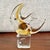 A sculptural vintage hand-blown glass fish featuring a stylized tropical form in warm amber and clear glass, mounted on a...