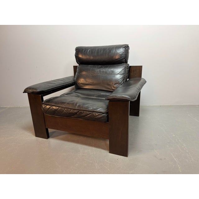 Striking Black Leather Brutalist Lounge Chair by Sonja Wasseur. Upholstered in deep black leather, this powerful design...