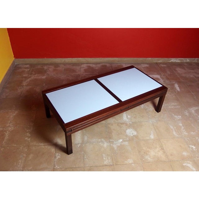 Japanese-inspired coffee table with an iroko wood base and six sliding, removable, and reversible iroko wood-framed...