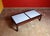 Japanese-inspired coffee table with an iroko wood base and six sliding, removable, and reversible iroko wood-framed...