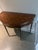 mahogany demi lune flip top console game table. On fluted legs with gilt bronze trim. Tooled leather top. Late 20th...