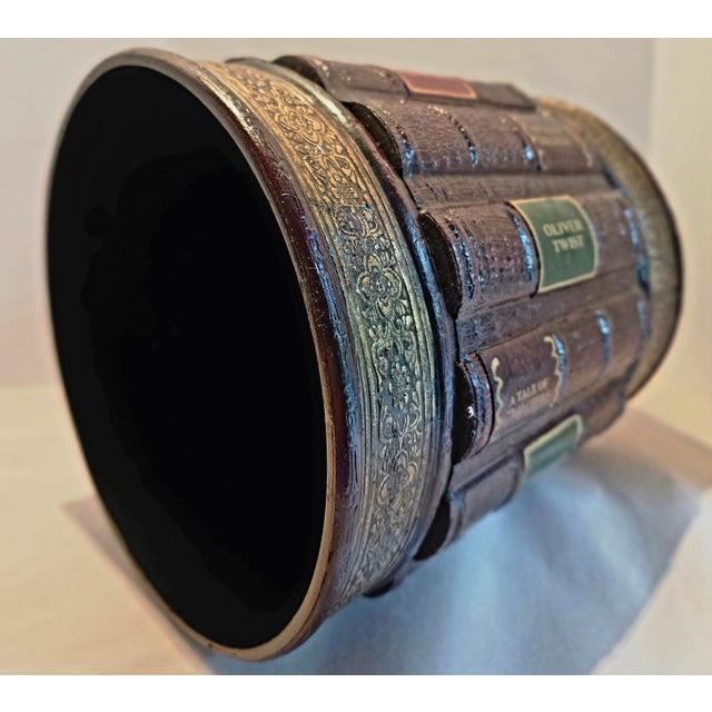 This attractive wood wastebasket features faux leather books from the classics with their spines bearing title labels,...