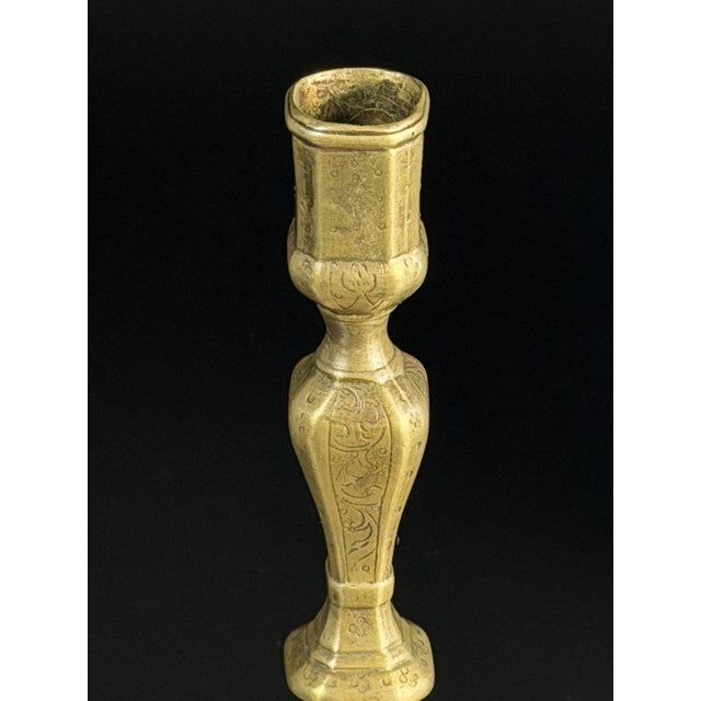 A finely proportioned Baroque brass candlestick dating to the first half of the 18th century, distinguished by its elegant...