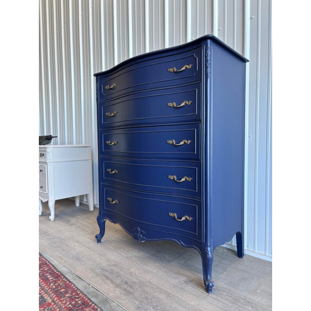 Elegant French Provincial–style chest refinished in a rich deep navy, paired with ornate gilded hardware that highlights...