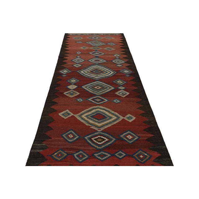 Handwoven in wool, circa 1950-1960, this 5x12 vintage tribal Afghan kilim runner rug features vibrant medallions and...