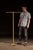 Freestanding industrial garment or display rack constructed from tubular steel with a heavy cast iron four-leg base and...