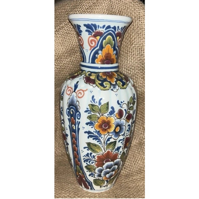 Beautiful vintage Delft Handwerk vase featuring a vibrant hand-painted polychrome floral design. This elegant piece...