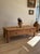 An inviting antique French coffee table crafted from richly grained fruitwood, its long, low proportions lending an...