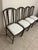 Great set of classic Hollywood Regency style dark metal or wrought iron dining side chairs with a distinctive loop-back...