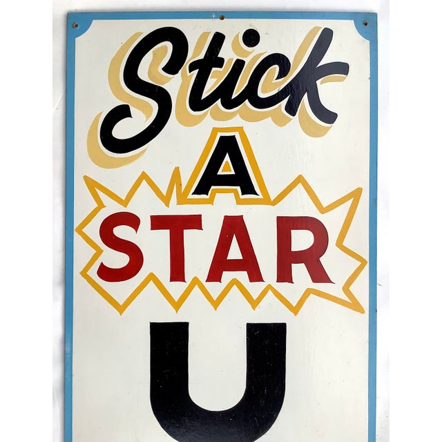 Colorful vintage hand painted on masonite "Stick A Star U Win" carnival sign from New Hampshire. Sign has some...
