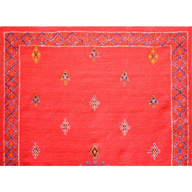 A bold vintage Moroccan flatware rug with three large medallions with stylized floral patterns against a crimson field...
