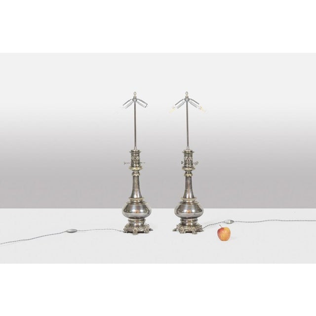 Pair of lamps in metal and silvered bronze, baluster shaped. Hexagonal base decorated with small leaves. French work...
