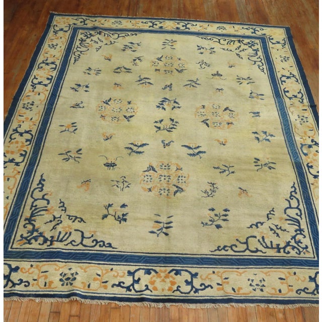 Early 20th Century room size Chinese rug highlighted with pops of orange . Professionally Cleaned and able to endure heavy...