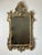 This Antique Late 18th Century Italian Baroque Gilt Gesso Wall Mirror is a magnificent representation of the ornate...