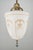 Neoclassical style pendant light with a stenciled milk glass shade, brass pole fitter and a steel ornate finial. This...