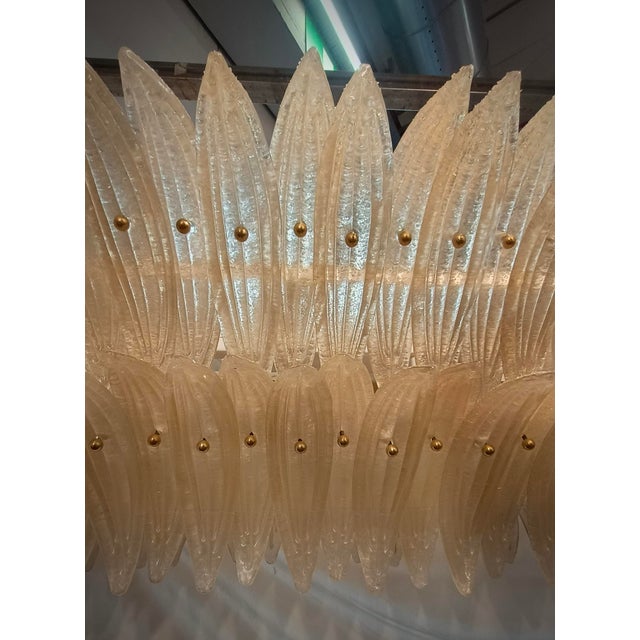 Fantastic Murano chandelier with an elongated design and brass structure. Note the shape of the palmette leaves that it is...