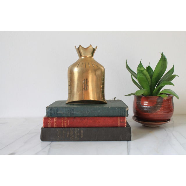 Vintage brass money bag bank or decorative object. One side has "Save it for a rainy day" etched. No makers mark. Some...