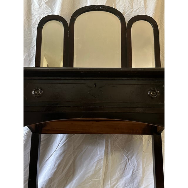 Vintage mahogany vanity with tri folding arched mirrors produced by The St. Lawrence Furniture Co. It is so dark it almost...