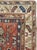 An antique Caucasian Kazak throw rug. The red field is divided by a subtle trellis with geometric palmettes and leaves in...