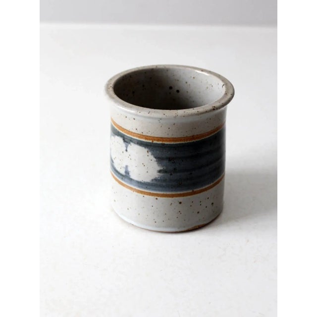 This vintage studio pottery cachepot features a speckled stoneware surface with a blue-gray glazed band framed by earthy...