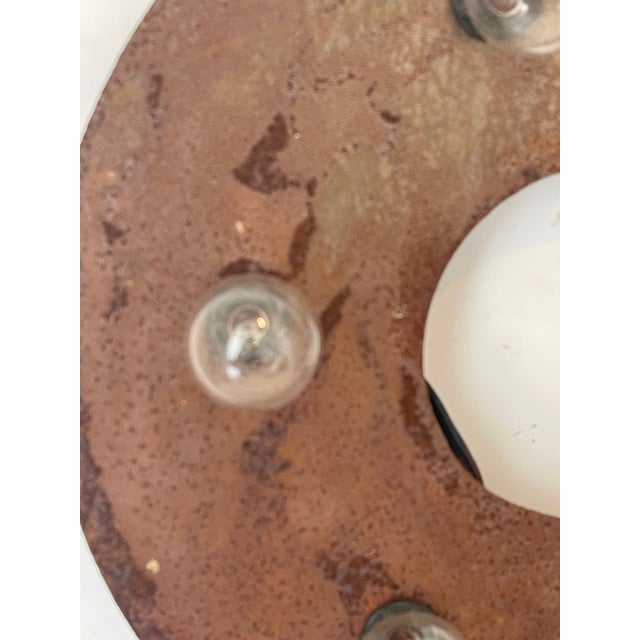 Handmade industrial rusted metal dollar sign wall light.