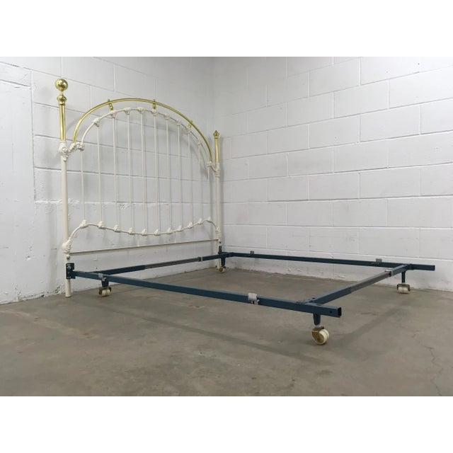 Mid twentieth century French white enameled wrought iron bedframe with brass headboard and ball finial on blue steel...