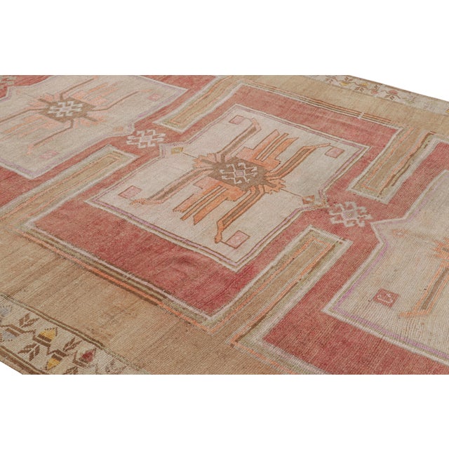 Hand Knotted in wool, this vintage 9x14 Turkish Oushak rug features prominent medallions and geometric patterns on a...