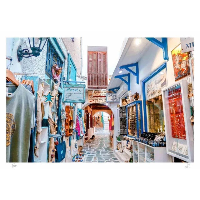 Greek Market is a photograph taken by Amanda Ludovisi in 2018. It represents a colorful narrow street inside the Greek...
