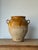 An extra-large French confit pot with a rich ochre glaze across the upper body, worn gracefully to reveal layers of...