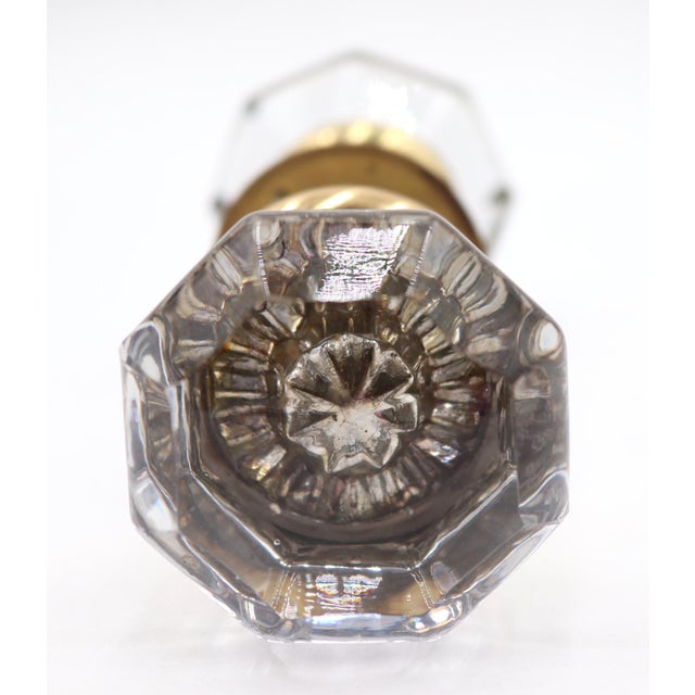 Vintage door knob set made of octagon shaped clear glass door knobs paired with newly made polished brass rosettes. The...