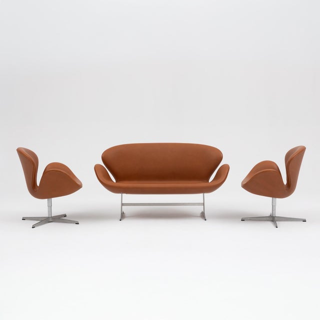 A sculptural and unmistakably modern “Swan” seating set designed by Arne Jacobsen in 1958 for the SAS Royal Hotel in...